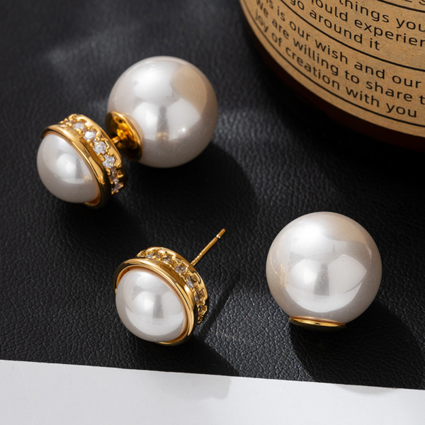 Elegant Pearl and Gold Hoop Earrings, with large Pearl Earrings. The earrings are set with a half faux pearl on the front, a ring of zirconia set around the perimeter metal surround, and a whole large faux pearl for the earbuds. The luster of the pearl can be seen on both the front and back when worn.