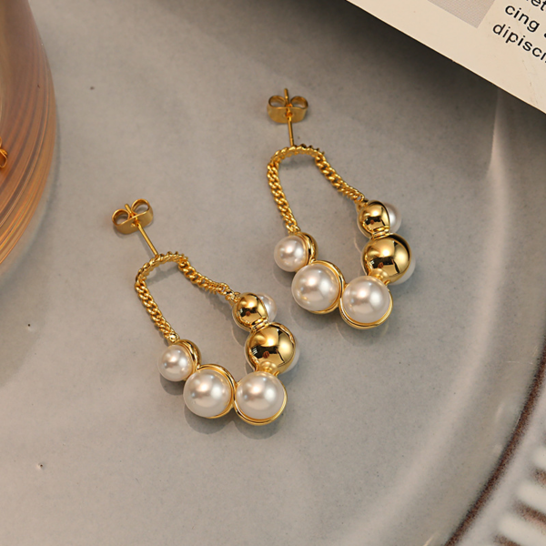 Sparkling Pearl Earrings, with golden chain. The earring backing is set with 3 different sized faux pearls on the front and 2 different sized ones on the reverse backing. When wearing the earrings, the luster of the pearls can be seen on both the front and back.