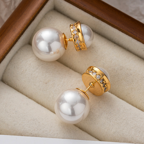 Elegant Pearl and Gold Hoop Earrings, with large Pearl Earrings. The earrings are set with a half faux pearl on the front, a ring of zirconia set around the perimeter metal surround, and a whole large faux pearl for the earbuds. The luster of the pearl can be seen on both the front and back when worn.