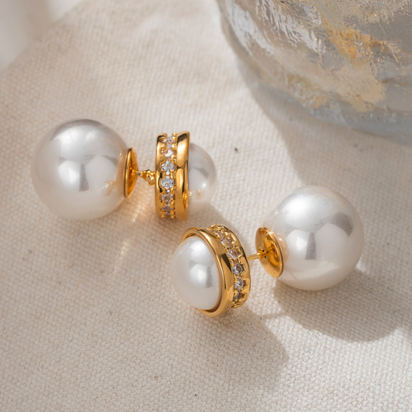 Elegant Pearl and Gold Hoop Earrings, with large Pearl Earrings. The earrings are set with a half faux pearl on the front, a ring of zirconia set around the perimeter metal surround, and a whole large faux pearl for the earbuds. The luster of the pearl can be seen on both the front and back when worn.