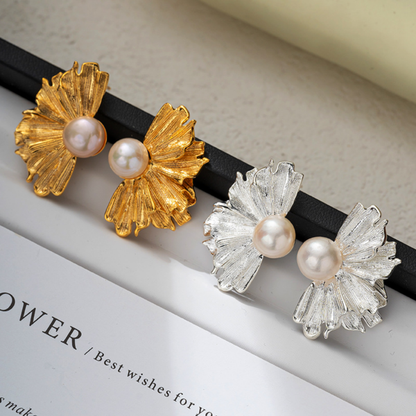 Natural pearl French floral textured earrings, golden and silver color, fan shape. The earrings have a natural freshwater pearl set in the center, and the left and right earrings each have the shape of a half-flower made of alloy, available in gold and silver color.