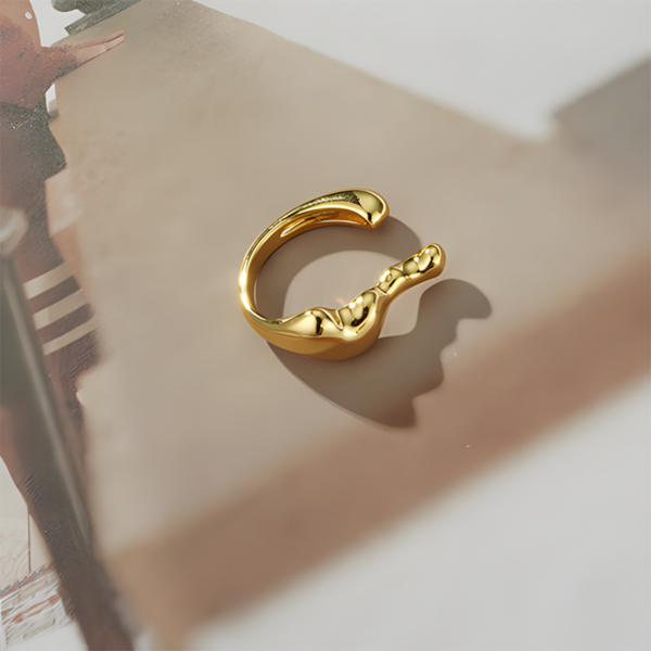 Elegant Streamline Split Ring - Golden Color, the shape like steam. This ring features a sleek, modern design characterized by its unique wavy shape. Crafted in a shiny gold finish, it showcases a combination of smooth and sculptural elements, giving it a contemporary feel. The open band allows for an adjustable fit, making it both stylish and comfortable for everyday wear. This eye-catching piece is perfect for adding a touch of elegance and artistic flair to any outfit.