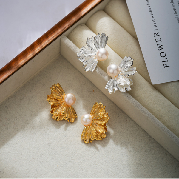 Natural pearl French floral textured earrings, golden and silver color, fan shape. The earrings have a natural freshwater pearl set in the center, and the left and right earrings each have the shape of a half-flower made of alloy, available in gold and silver color.